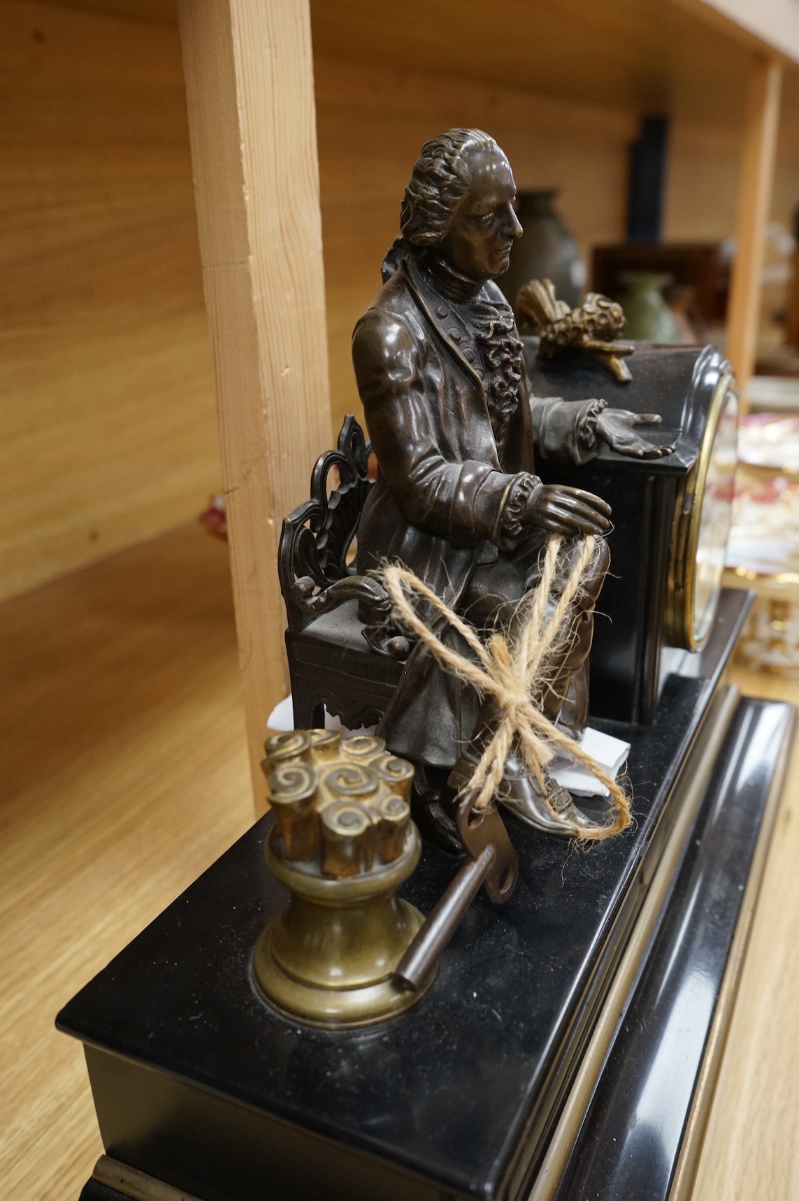 A 19th century French bronze and slate 8 day mantel clock, mounted with figure of Denis Diderot (1713-1784), 40cm wide